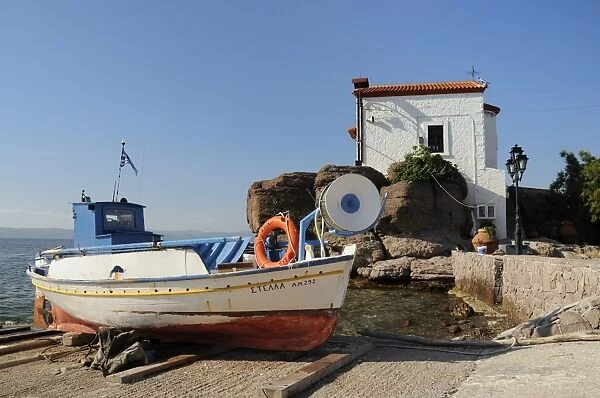 Fishing boat Stella on ramp near small chapel at Skala Sikaminia, Lesbos (Lesvos), Greek Islands, Greece, Europe