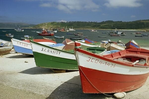 Fishing boats on the beach and in the harbour of the