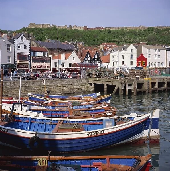 Fishing boats in the harbour, with the castle on the hill behind, Scarborough
