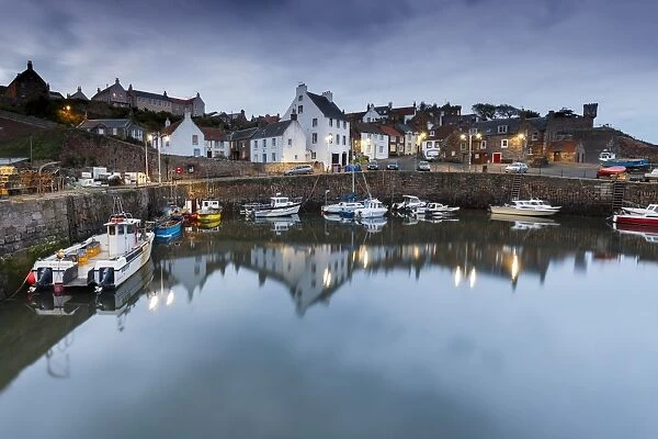 Fishing boats in the harbour at Crail at dusk, East Neuk, Fife, Scotland, United Kingdom