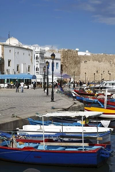 Fishing boats, old port canal with kasbah wall in background, Bizerte, Tunisia