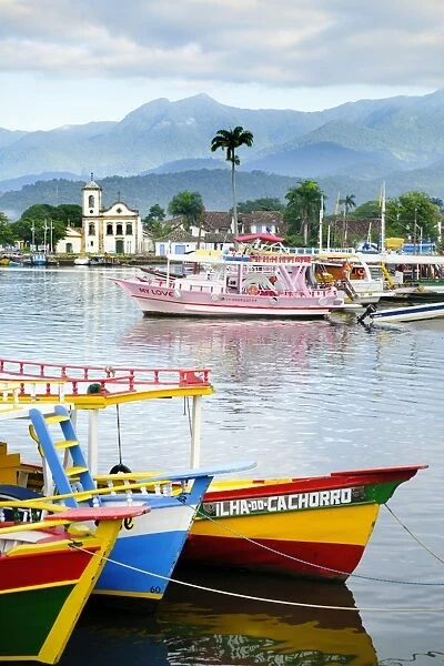 Fishing boats in Paraty village with the mountains of the Serra da Bocaina behind