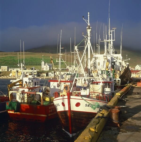 Fishing boats by the quay in the harbour at Husavik