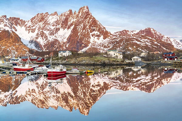 Fishing boats and snowcapped mountains mirrored in the fjord at sunrise, Ballstad, Vestvagoy, Lofoten Islands, Norway, Scandinavia, Europe