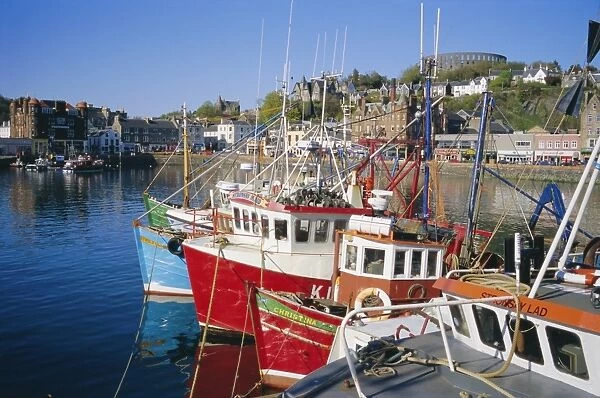 Fishing boats and waterfront with McCaigs Tower on hill