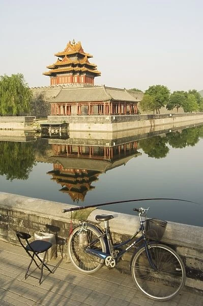 Fishing in the moat with a reflection of the Palace Wall Tower of The Forbidden City Palace Museum