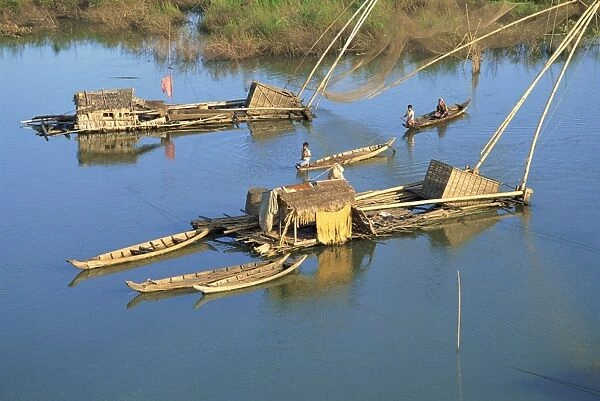 Fishing rafts and fishermen on canoes in Cambodia, Indochina, Southeast Asia, Asia