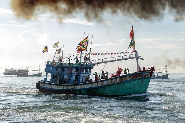 A fishing trawler at sea, taking part in the annual whale festival, with a lion dance