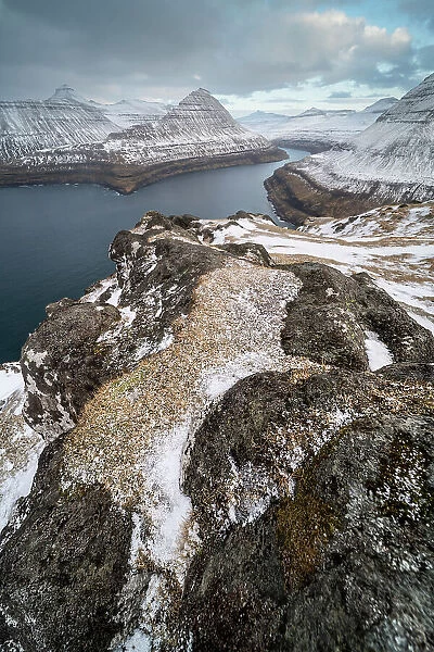Fjord view and snow covered rocks and mountains, Funningur, Esturoy Island, Faroe Islands, Denmark, Europe