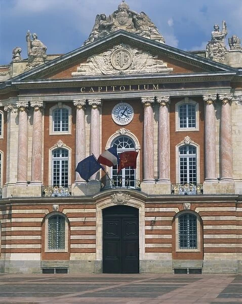 Flags flying below a clock on the Capitole building in Toulouse, Haute Garonne