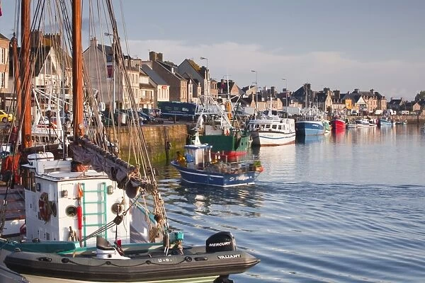 The Fleur de Lampaul, a protected historic monumen in the foreground, and small boat in the harbour at Saint Vst La Hougue, Cotentin Peninsula, Normandy, France, Europe