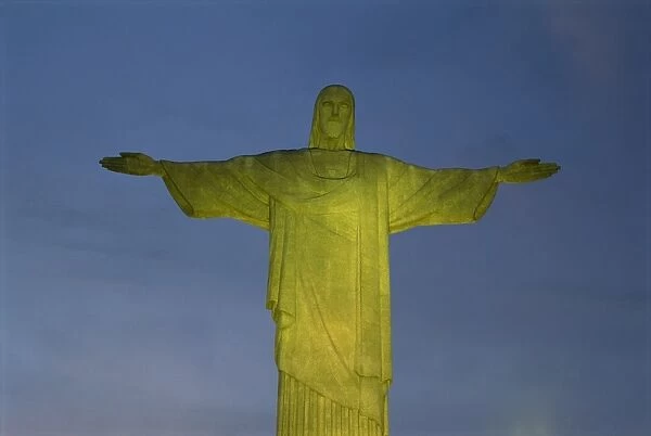 Floodlit statue of Christ the Redeemer at 710m on Mount Corcovado, above Rio de Janeiro