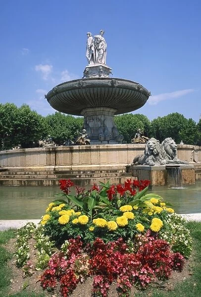 Flowers in front of La Rotonde fountain in Aix en Provence, Provence, France, Europe
