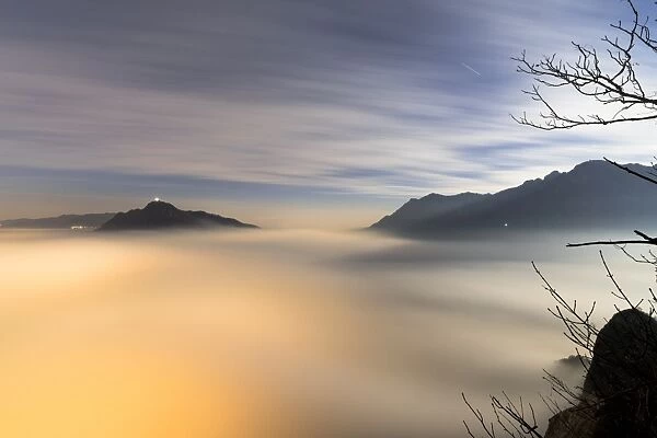 Fog and clouds at dawn seen from Monte San Martino, Province of Lecco, Lombardy, Italy