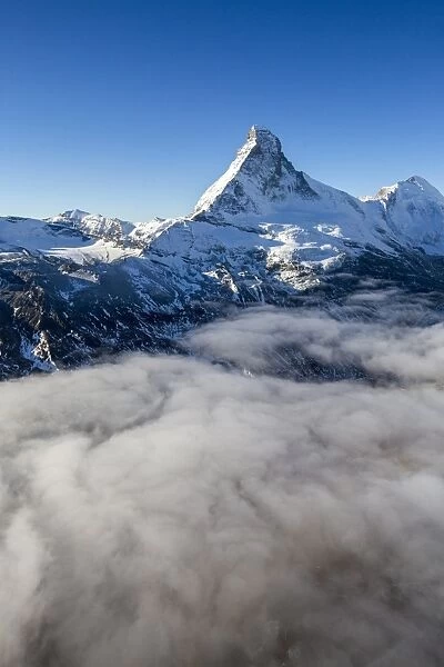 Fog revealing the mountain range surrounding the massif of the Matterhorn, Swiss Canton of Vaais, Swiss Alps, Switzerland, Europe