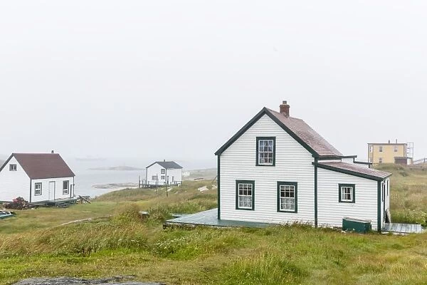 Fog rolls in over the small preserved fishing village of Battle Harbour, Labrador, Canada, North America