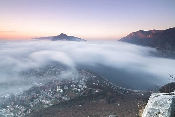 Fog at sunrise above the city of Lecco seen from Monte San Martino, Province of Lecco