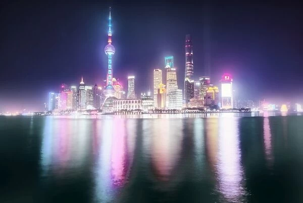Foggy yet colorful skyline of Shanghai Pudong at night, Shanghai, China, Asia
