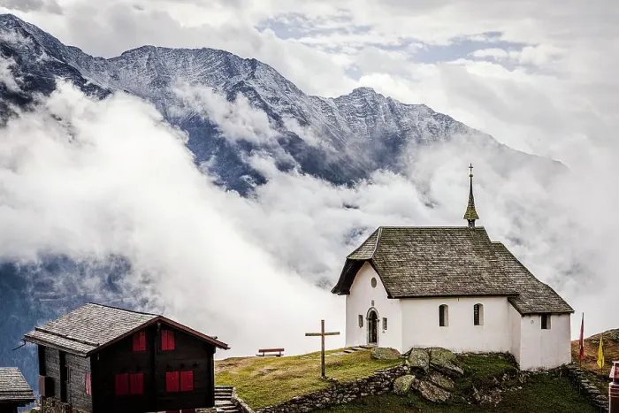 Framed Print : Foggy sky over the small church in the alpine village of Bettmeralp, canton of Valais, Switzerland, Europe Framed Print : Foggy sky over the small church in the alpine village of Bettmeralp, canton of Valais, Switzerland, Europe