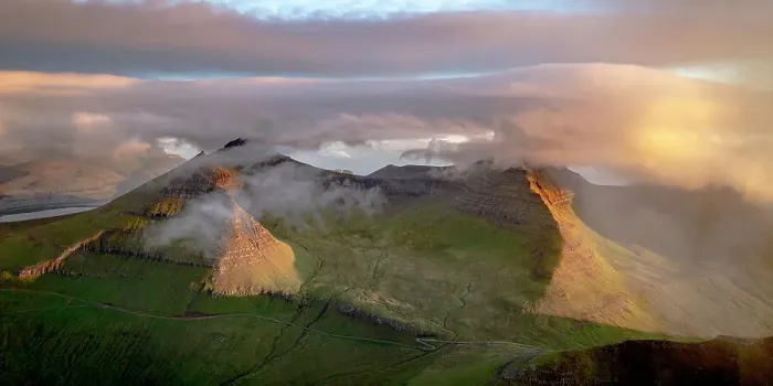 Framed Print : Foggy sunrise over Slaettaratindur peak, highest mountain of Faroe Islands, aerial view, Eysturoy Island, Denmark, Europe Framed Print : Foggy sunrise over Slaettaratindur peak, highest mountain of Faroe Islands, aerial view, Eysturoy Island, Denmark, Europe