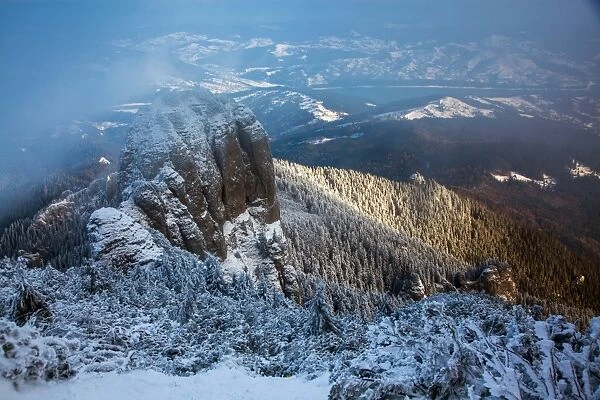Foggy winter landscape in Ceahlaul Massif, Romania, Europe