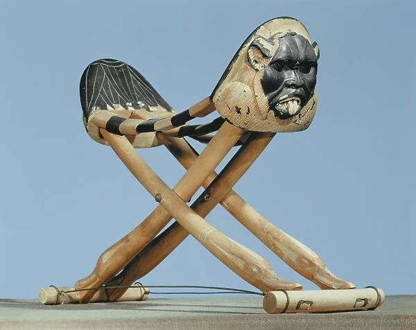Folding headrest in painted ivory decorated with the head of the protective spirit Bes