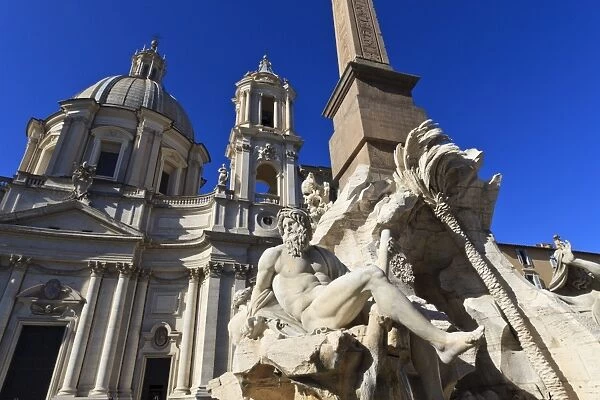 Fontana dei Quattro Fiumi, topped by the Obelisk of Domitian with the Sant Agnese in Agone, Piazza Navona, Rome, Lazio, Italy, Europe