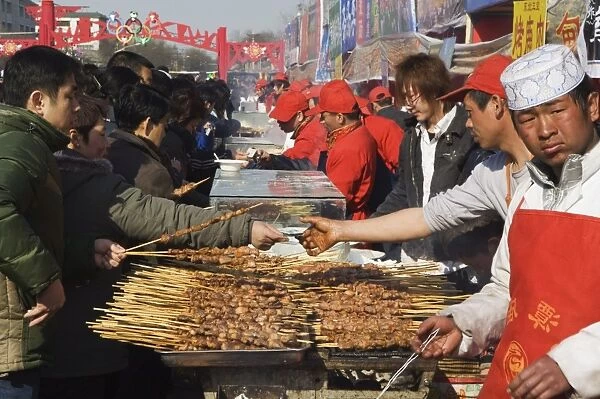 Food stalls selling meat sticks at Changdian Street Fair during Chinese New Year