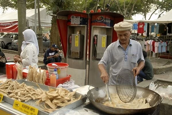 Food vendor frying food outside Central Market