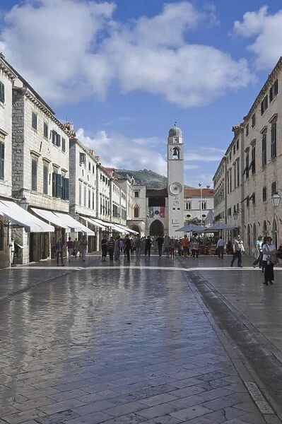 Foot worn glossy roadway in the main street dominated by the clock tower. medieval city of Dubrovnik, UNESCO World Heritage Site, Croatia, Europe