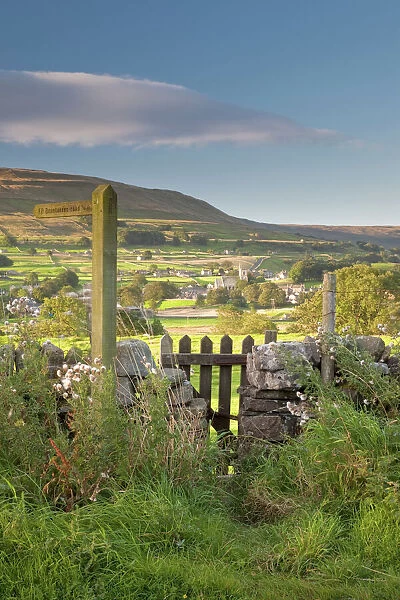 A footpath signpost and gate leading to Hawes village in Wensleydale, The Yorkshire Dales