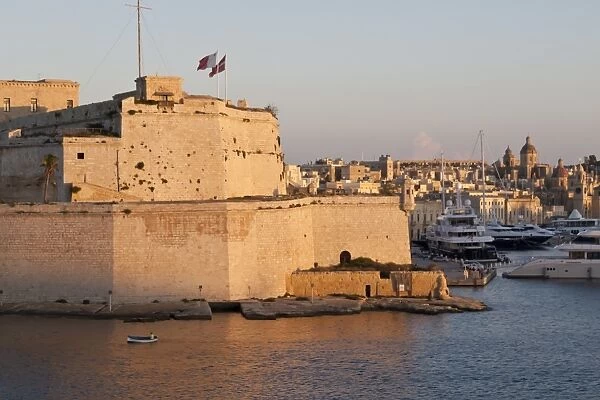 Fort St. Angelo, fishing boat and Vittoriosa (Birgu) at sunset, Grand Harbour, Valletta, Malta, Mediterranean, Europe