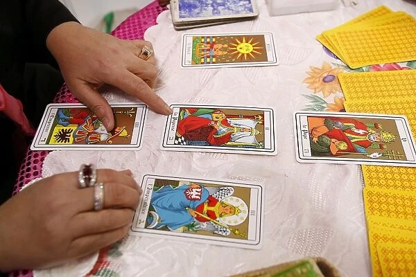 Fortuneteller laying cards on the table during a divination, Paris, France, Europe