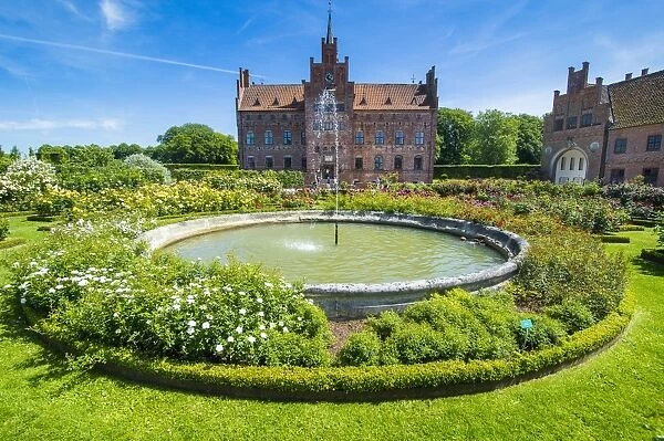 Fountain and roses in front of Castle Egeskov, Denmark, Scandinavia, Europe