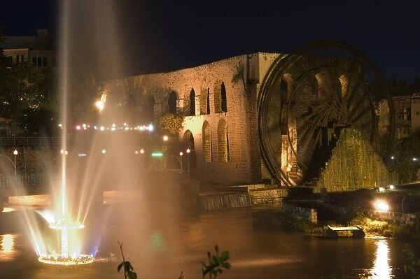 Fountain and water wheel on the Orontes River at night