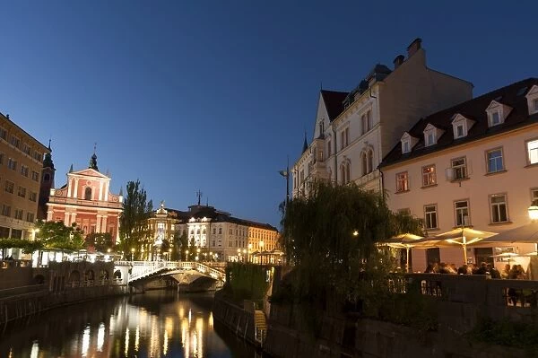 Franciscan Church of the Annunciation and Triple Bridge over the Ljubljanica River at dusk