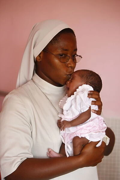 Franciscan sister holding an orphan at nursery and kindergarten run by Catholic nuns