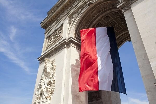French flag under Arc de Triomphe built by Napoleon, Paris, France, Europe