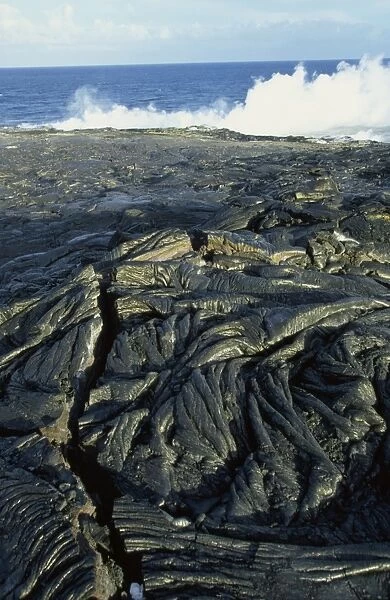 Fresh pahoehoe or ropey lava, close to where steam rises from lava entering the sea on the southeast Puna coast, Big Island, Hawaii, Hawaiian Islands, United States of America, Pacific