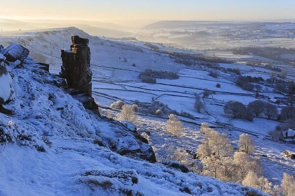 Fresh snow on Curbar and Baslow Edge with misty Derwent valley and winter trees, Peak District, Derbyshire, England, United Kingdom, Europe