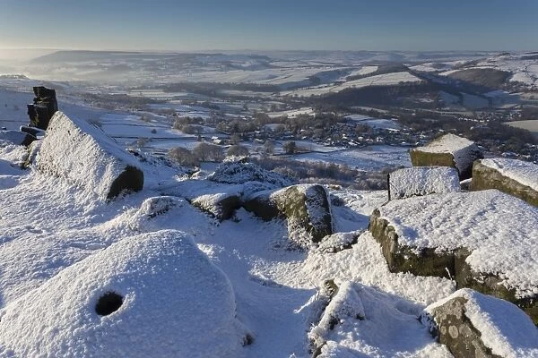 Fresh snow on millstone, Curbar Edge, misty Derwent Valley with Curbar and Baslow villages, Peak District, Derbyshire, England, United Kingdom, Europe