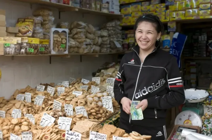 Framed Print : Friendly woman selling biscuits at a market stand, Alma Ata, Kazakhstan