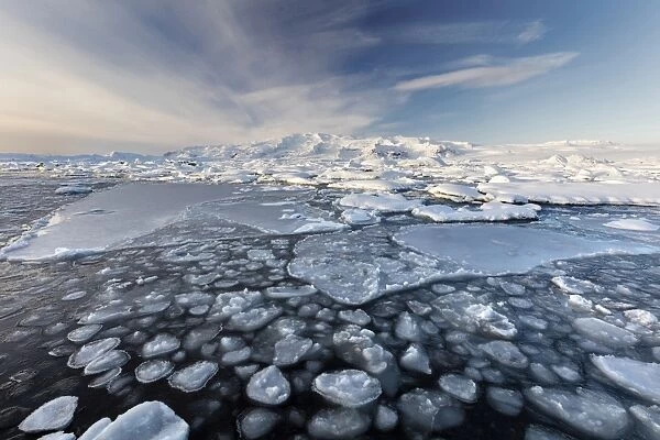 Frozen Jokulsarlon Glacial Lagoon in winter with ice in the foreground and snow covered