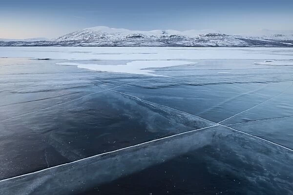 A frozen lake, so clear its possible to see through the ice, near Absiko, Sweden, Scandinavia, Europe