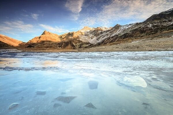 Frozen lake Montespluga at dawn, Chiavenna Valley, Sondrio province, Valtellina, Lombardy