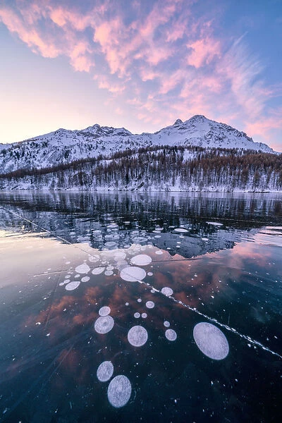 Frozen Lake Sils at sunrise with Piz Da La Margna in background, Engadine