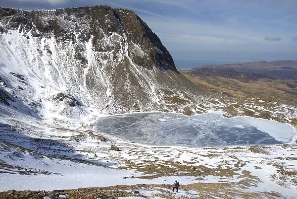 The frozen Llyn Y Gadair below summit of Cyfrwy, 811m, near Cadair Idris, Snowdonia National Park, Wales, United Kingdom, Europe