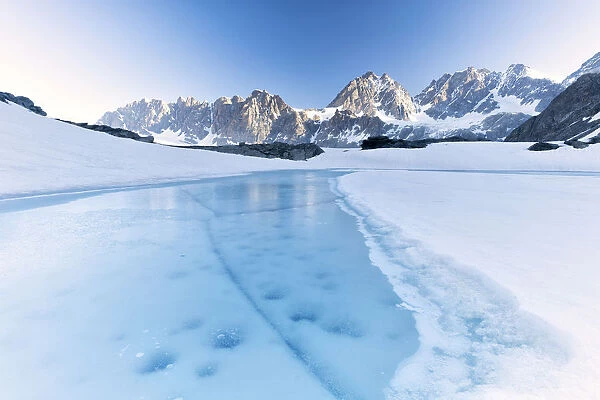 Frozen water of Forbici Lake during the spring thaw, Valmalenco, Valtellina