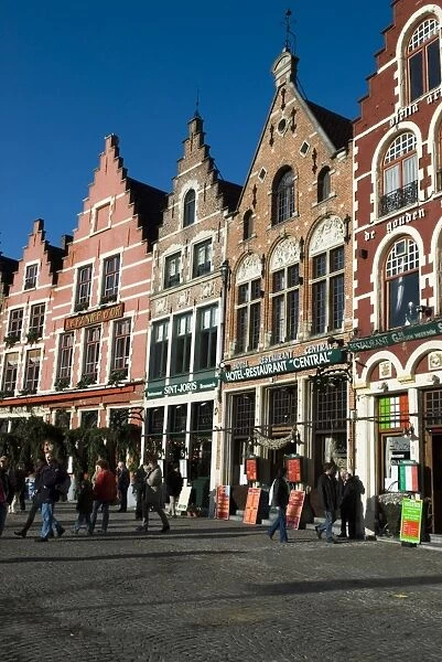 Gabled fronted restaurants in the Market Square at Christmas, Bruges, West Vlaanderen (Flanders), Belgium, Europe