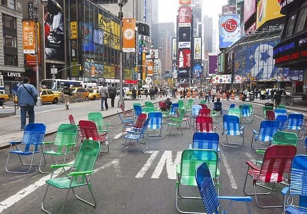 Garden chairs in the road for the public to sit in the pedestrian zone of Times Square